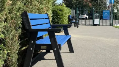 Blue bench beside green hedges British Recycled Plastic