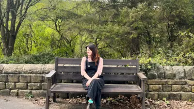 Woman sitting on a British Recycled Plastic bench
