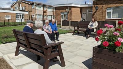 Residents enjoying time in communal garden at British Recycled Plastic Ilkley Bench