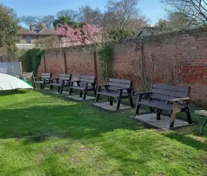 york-cc-ilkley.jpg 5 recycled plastic benches inside a walled garden
