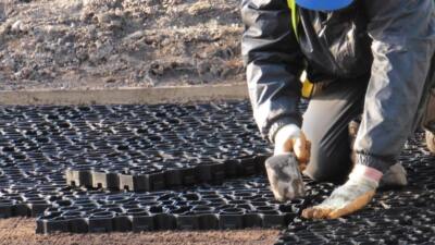 Groundworker laying Hebden X Grid gravel grids