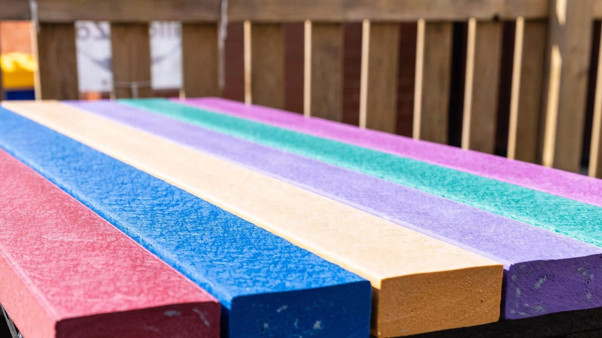 Rainbow coloured artificial lumber table top.