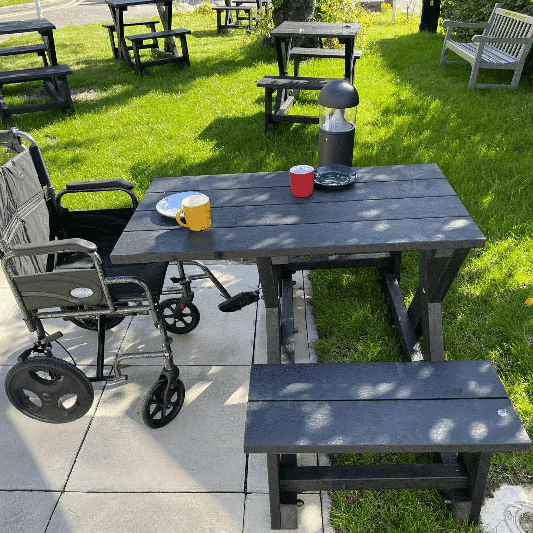 Grass area with recycled plastic wheelchair accessible picnic tables
