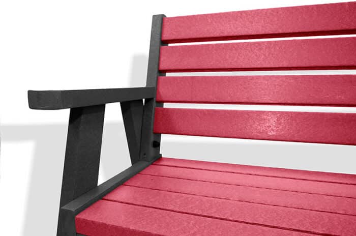 The classic recycled plastic Ilkley bench with arms, with a black frame and red slats.