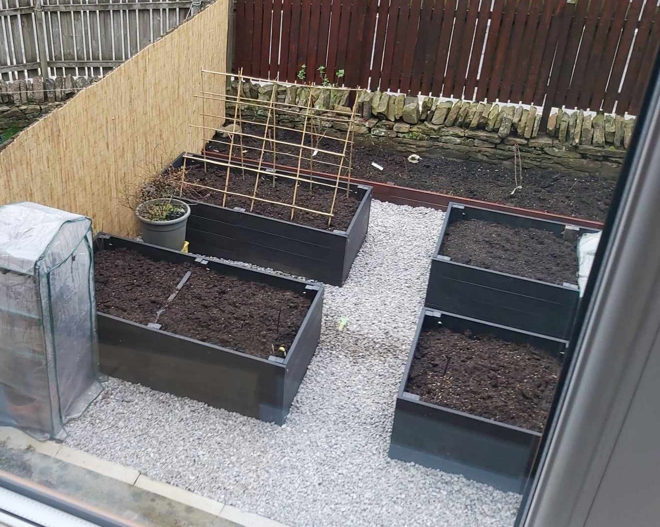 Recycled plastic raised beds laid out for planting