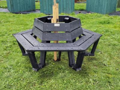 Wrap around hexagonal bench with tree in the center.