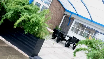 Outdoor seating area with greenery. British Recycled Plastic Planter