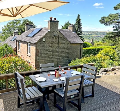 Small grey Birchcliffe dining set made from recycled plastic, set up on an outdoor deck, perfect for enjoying meals al fresco.