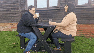 friends having a cup of tea outside on our wainsgate walkthrough space saving picnic tables