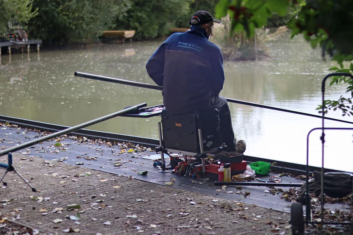 An angler on a recycled plastic fishing peg at Slipper Bridge Angling Club