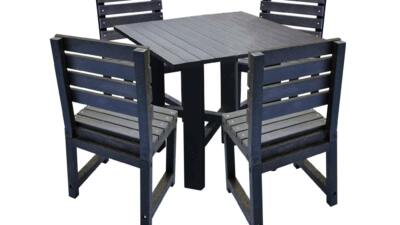 Black square garden table with matching black chairs made from recycled plastic.