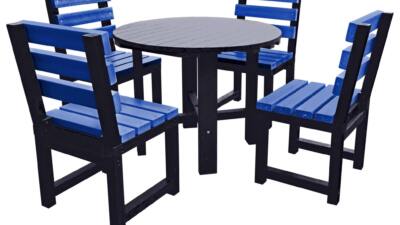 Black round garden table with four blue chairs made from recycled plastic.