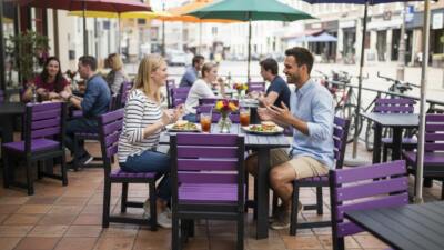 Couple enjoying a drink at a bar at a British Recycled Plastic square Featherstone dining set