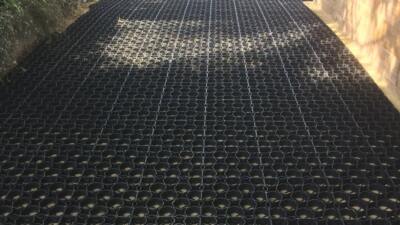 Residential driveway featuring our everyday permeable ground reinforcement grids, leading to a twin garage at the end.