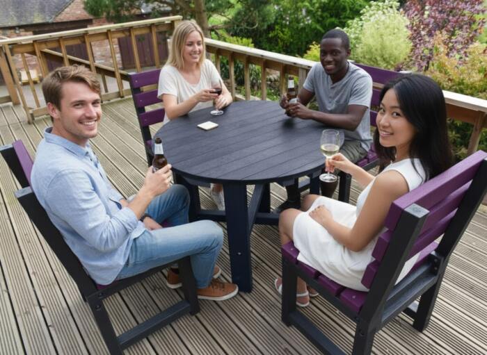 garden-set-Featherstone-dining-purple-black-pub-garden (2) friends sat round a British Recycled Plastic round Featherstone dining set
