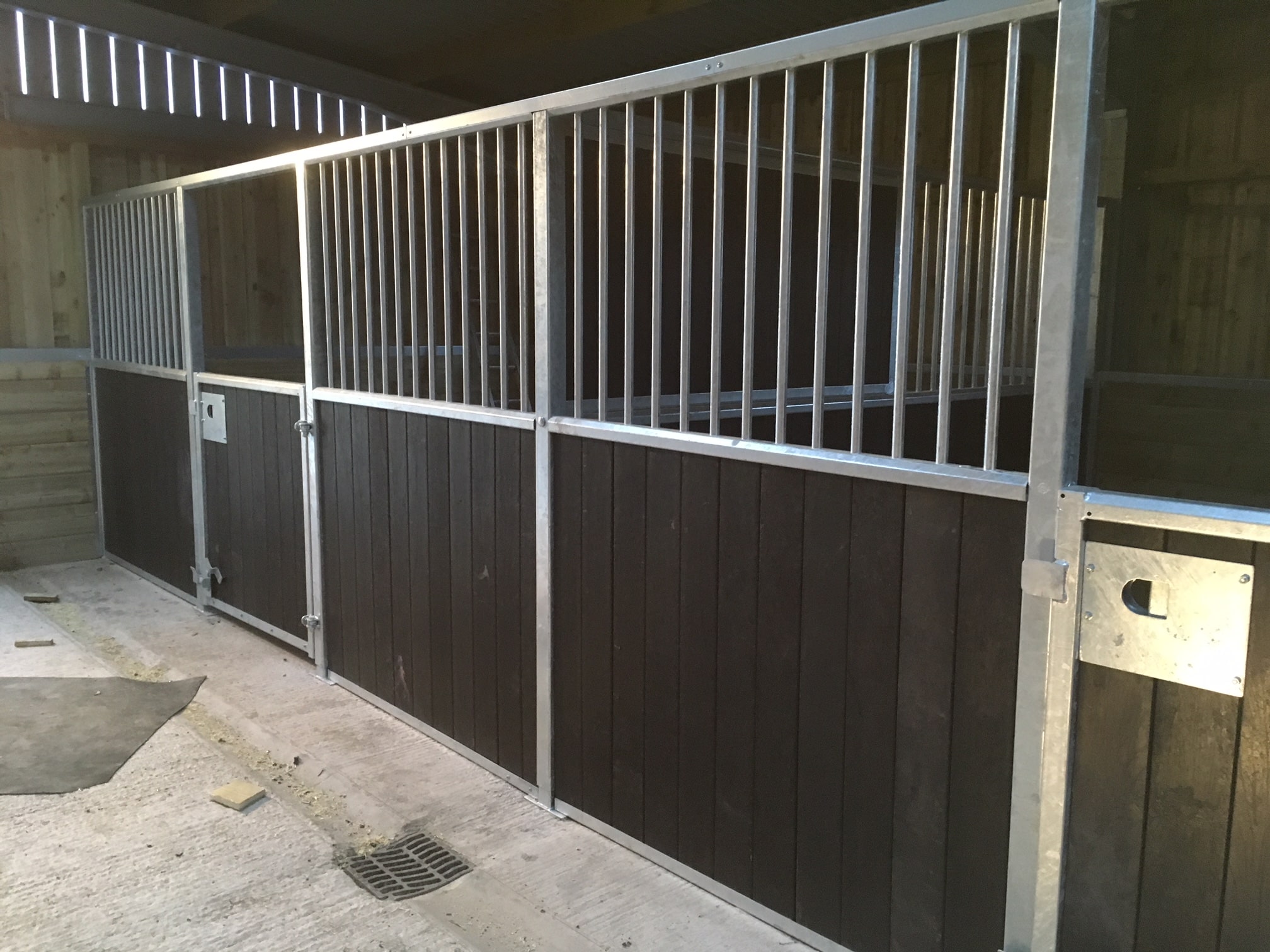 Why Plastic Fencing is the Future of Sustainable Boundaries 3 a metal fence in a stable using british recycled plastic artificial lumber