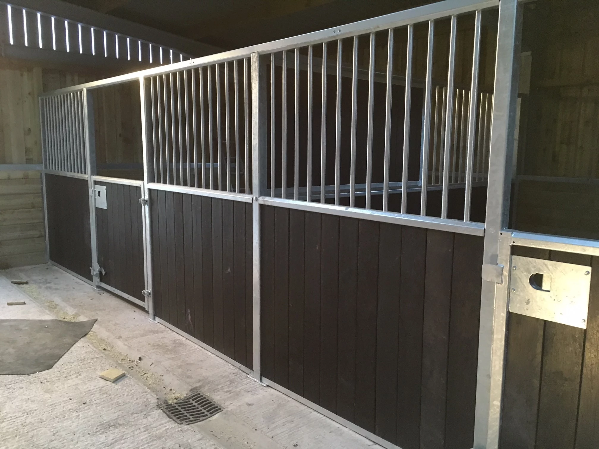 a metal fence in a stable using british recycled plastic artificial lumber