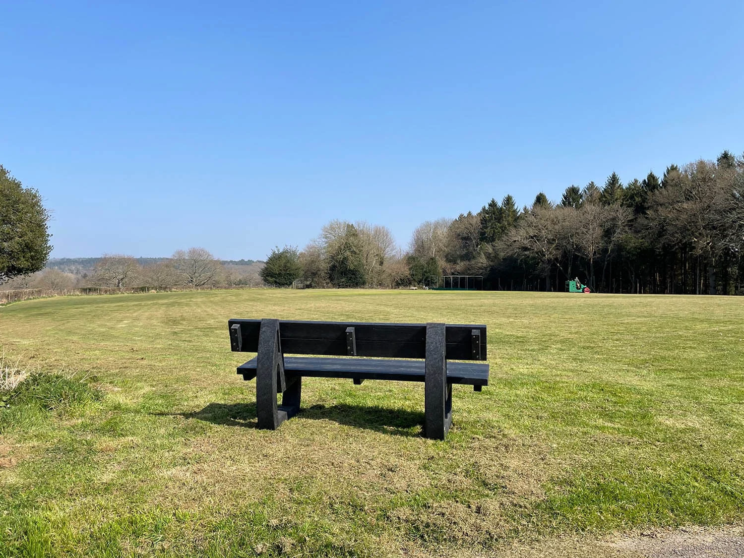 rear view of a black british recycled plastic buddy bench made from artificial lumber outdoor bench