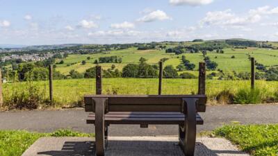 A maintenance free Harewood recycled plastic bench by the side of the road near Nelson in Lancashire