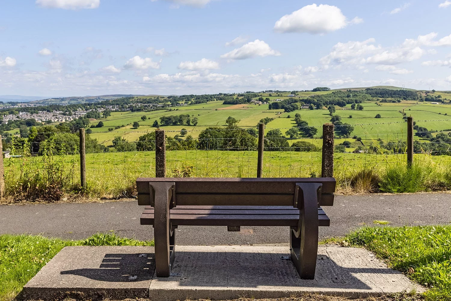 A maintenance free Harewood recycled plastic bench by the side of the road near Nelson in Lancashire