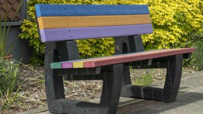 1 rainbow coloured British recycled plastic bench that would sit 2 people