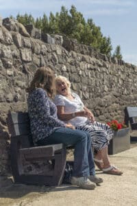 Enjoying a well-postioned recycled plastic Harewood bench from British Recycled Plastic