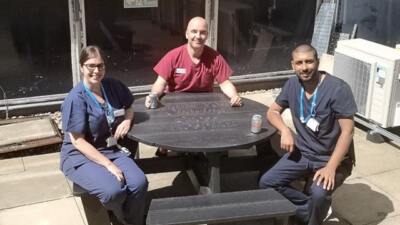 Medical staff taking a well earned break at Charing Cross Hospital during the pandemic at a British Recycled Plastic circular Calder picnic table.