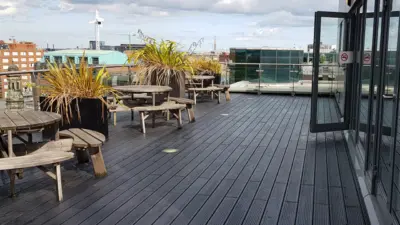 Outdoor seating area with plants and recycled plastic decking