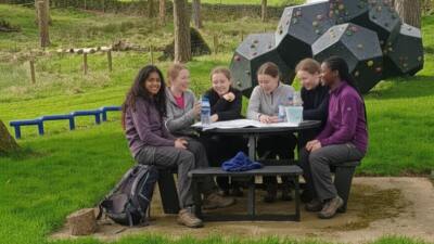 Girls gathered around a British Recyled Plastic Calder picnic table