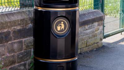 recycled plastic litter bin near a school