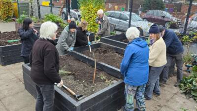 A community planting a raised bed kit from British Recycled Plastic