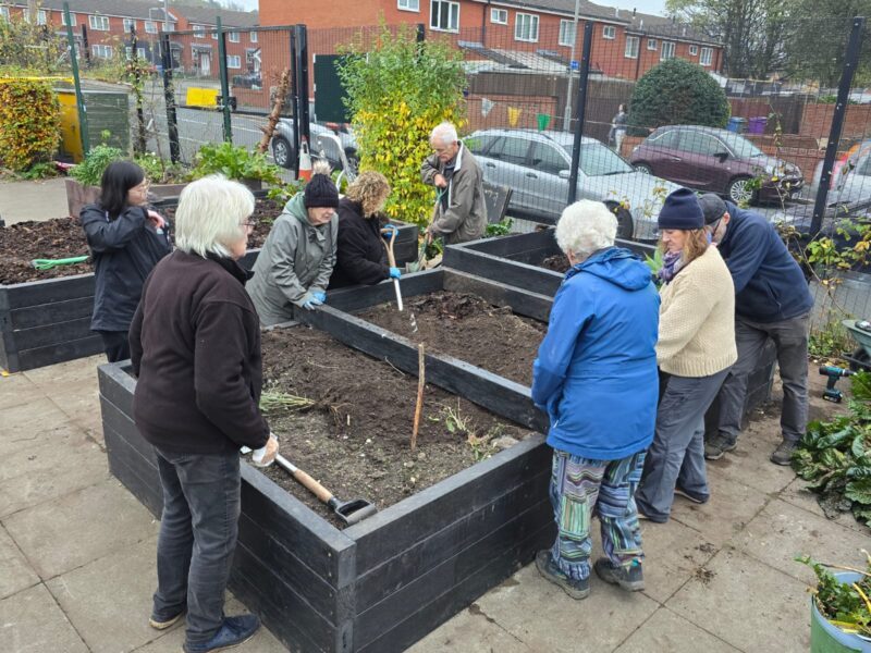 A community planting a raised bed kit from British Recycled Plastic