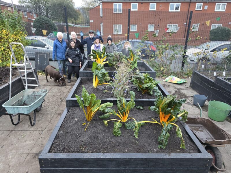 peoples smiling for a photon after planting British Recycled Plastic raised beds