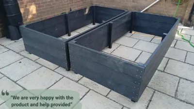 Dark wooden raised garden beds. British Recycled plastic