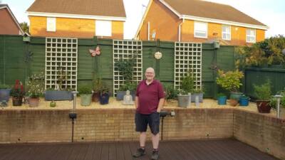 Decking done in brown recycled plastic decking lumber our customer standing on his new decking