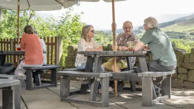 People talking sat at a Rishworth table in a lovely country pub