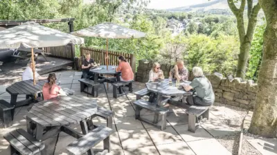 people sat around Rishworth tables in a pub