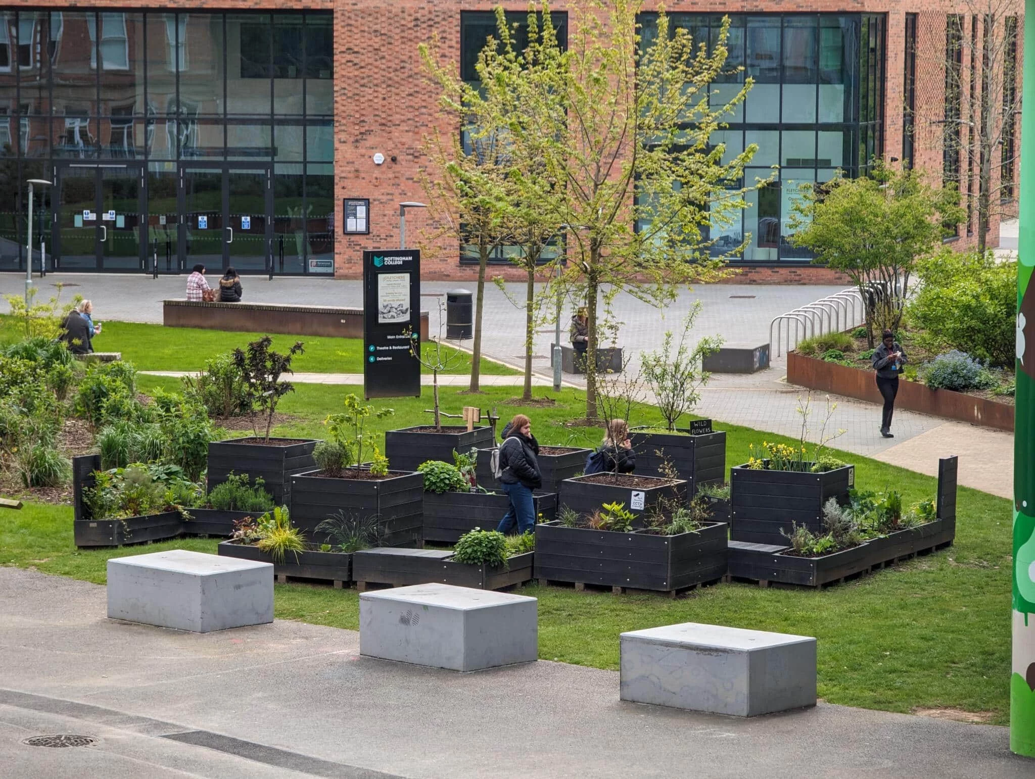 Recycled plastic parklet on grassed area outside school