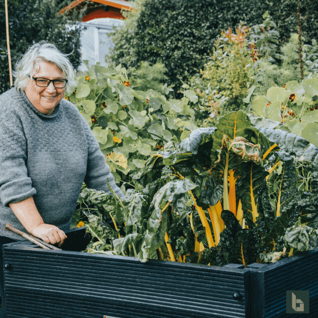happy lady with British recycled plastic aised beds