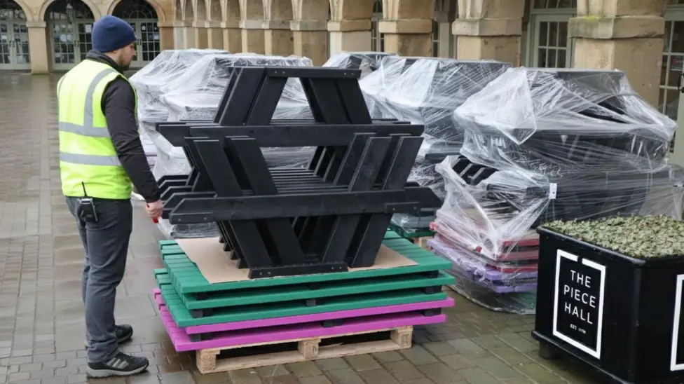 British Recycled Plastic tables stacked and ready to be put up at the piece hall