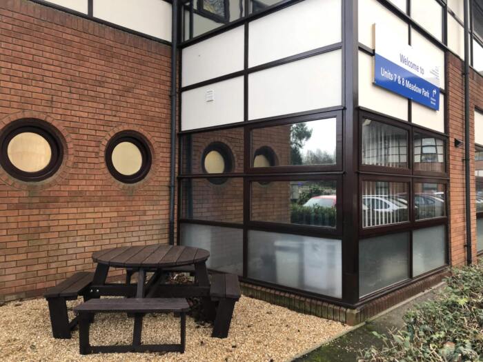 Calder_Cambridge_NHS_Trust A calder round picnic table outside an nhs hospital