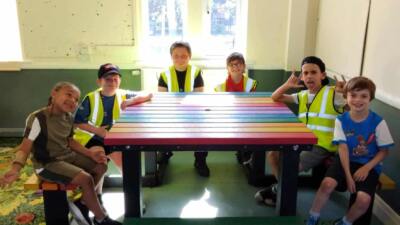 Rainbow brimham picnic table with child sat around in classroom