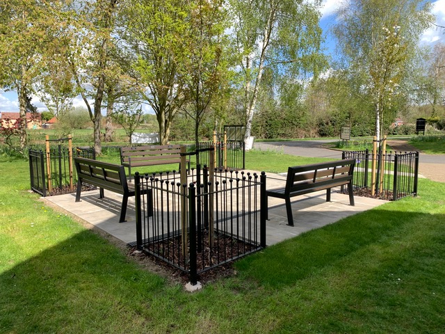Accessible Outdoor Furniture in Action: Recycled Plastic Benches at Wells Cole Community Centre 3 The Wells Cole Community Centre Garden, with 3 recycled plastic York accessible benches, 4 trees in the corners of the garden, and flat paved ground for ease of access.