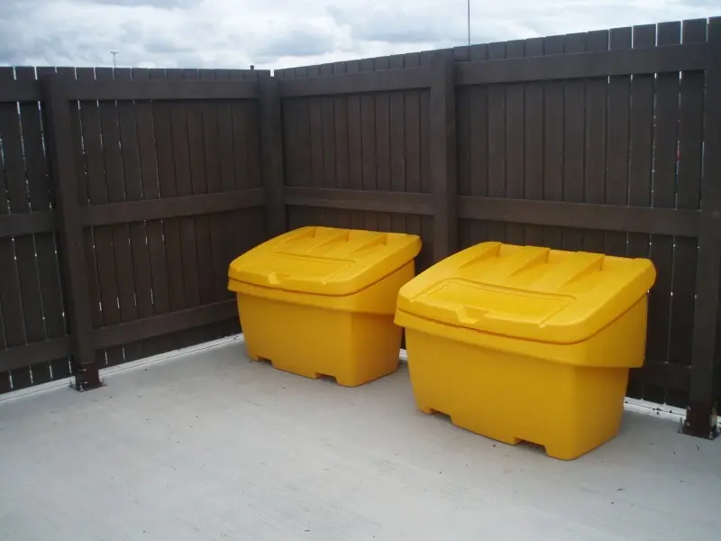 Bespoke fence panels cut to a specific size by British Recycled Plastic. The vertical fence slats are made from 100% recycled plastic, and surround two salt grit bins.
