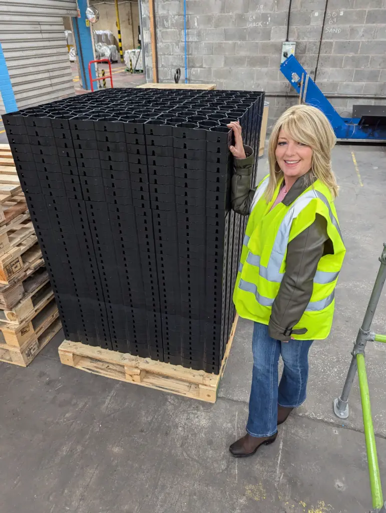hebden-everyday-grids-nat-single-stack (1) Staff next to recycled plastic permeable paving grids (Nat)