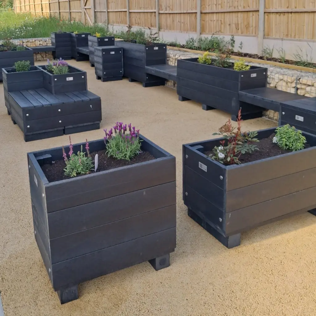 Parklet square 1 rectangular recycled plastic parklet with flowers in a community space